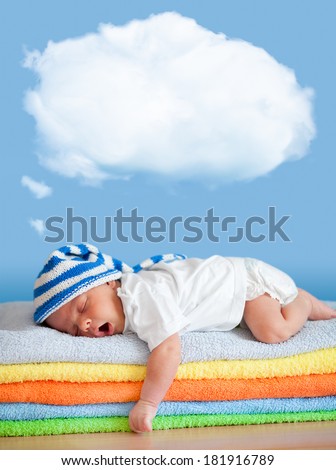 Yawning sleeping baby in funny hat with dream cloud for image or text