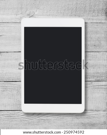 Tablet pc similar to ipad on wood table background