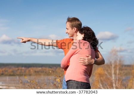 Young man shows to his pregnant wife their future home location