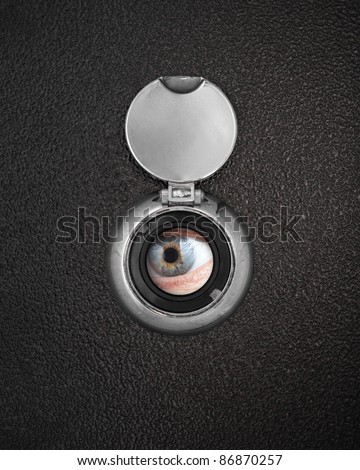 Human eye in peep hole closeup