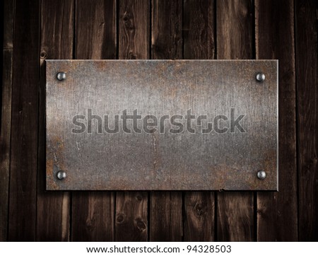 rusty metal plate on wooden background