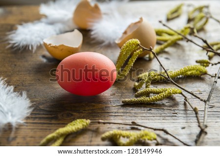 easter eggs and feathers on an old wooden table