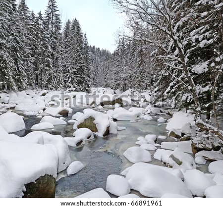 mountain river with big stones in winter time