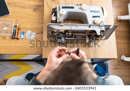 Similar – Image, Stock Photo Repairman fixing old broken motorcycle in workshop