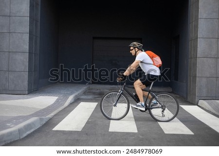 Similar – Image, Stock Photo healthy man riding a bicycle on a mountain road in a sunny day