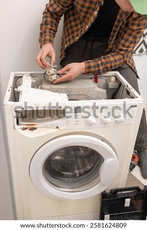 Similar – Image, Stock Photo Repairman fixing old broken motorcycle in workshop