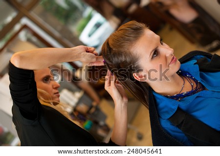 Young woman in hairdresser saloon having a haircut