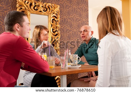 Four people having a debate in cafe