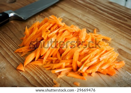 carrots cut into a wooden board and knife