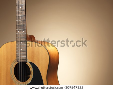 Shot of an acoustic guitar close up with a colored background and copy space.