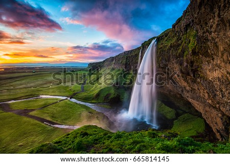 Seljalandsfoss - Seljalandsfoss is located in the South Region in Iceland right by Route 1. One of the interesting things about this waterfall is that visitors can walk behind it into a small cave.

 Foto d'archivio © 