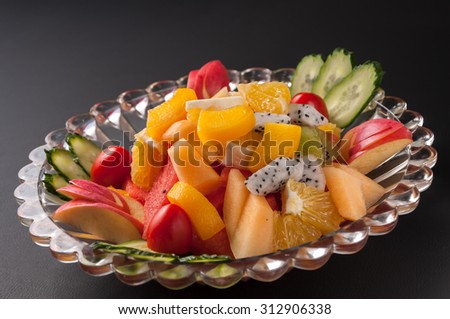 Colorful fruit platter with watermelon, cantaloupe, grapes, oranges, Dragon fruit and mint