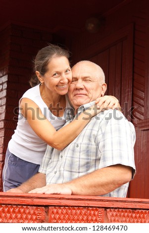 elderly couple sitting on a porch