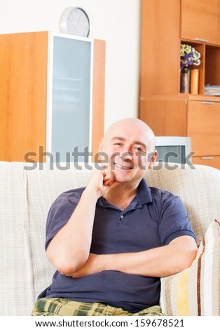 Relaxed man sitting on couch