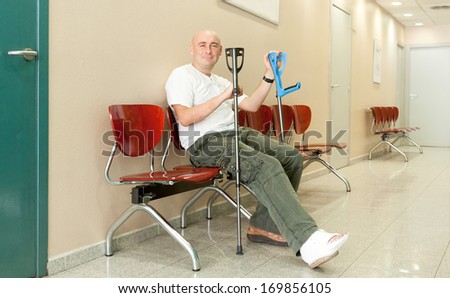 man with  plaster on his leg and crutches