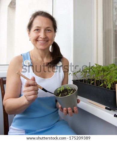 woman aged grows vegetables on  balcony