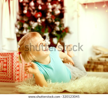 Little blond baby on   floor during    New Year's Day