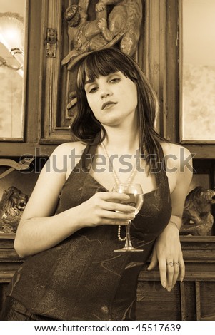 Styled lady with glass of wine over vintage interior