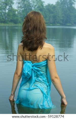 Sexy girl in  blue wet dress at lake