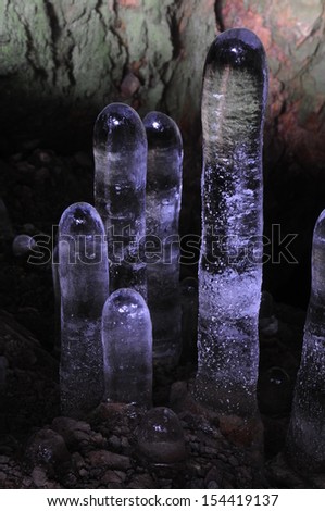 A group of thawing ice stalagmites photographed at sunset.