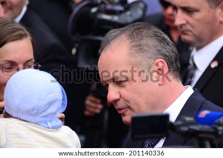BRATISLAVA, SLOVAKIA - JUNE 15, 2014 President Andrej Kiska with a baby during the presidential inauguration on June 15, 2014 in Bratislava, Slovakia.