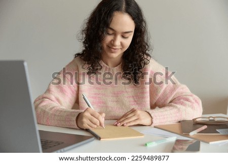 Similar – Image, Stock Photo Thoughtful woman taking notes in notebook in cafe