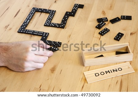 Playing domino game on a desk