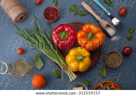 Multi-colored sweet peppers on a blue board; the substrate for the menu bars and restaurants; recipes; ingredients for cooking; healthy eating; Tips for weight loss; diet