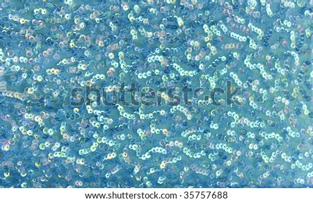 Teal background of sequins and mesh fabric