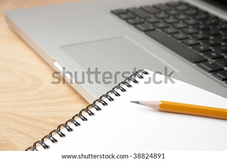 Notepad Pencil and Computer Laptop