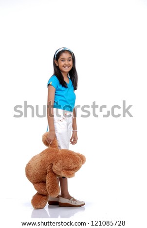 Portrait of cute girl with her teddy bear over white background