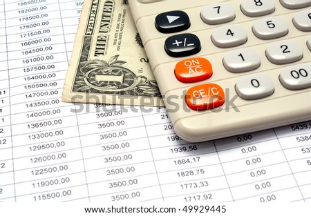 The calculator and dollar lie on the schedule of payments under the credit