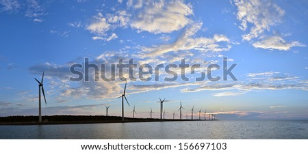 it\'s a panorama wind-power station with clouds and blue sky