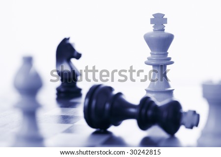 Chess game white king defeating black king blue tone