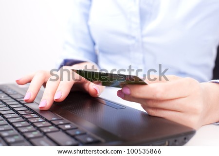 Business woman typing and making on-line payment with credit card