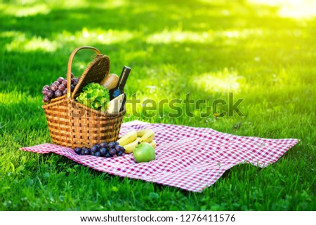 Similar – Foto Bild Picknick-Korb mit Wein, Baguette, Weinglas, Blumen, Kerze und Picknick-Decke auf grünem Gras Hintergrund. Romantisches Picknick Vorbereitung im Sommer. Ansicht von oben.