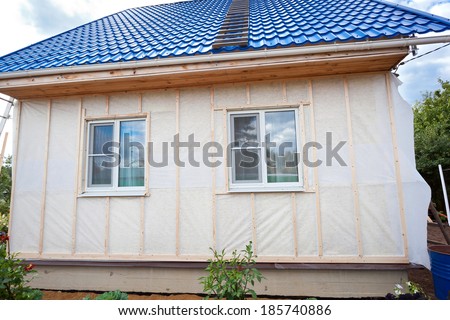 External wall insulation in wooden house,  building under construction