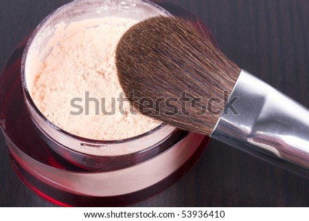Professional make-up brush on box with powder, closed-up