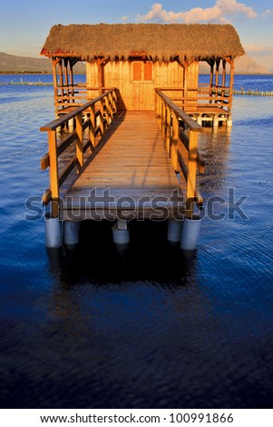 wood bridge and house on the sea