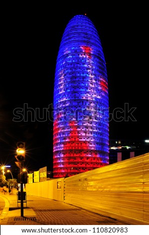 BARCELONA, SPAIN - AUGUST 15: Torre Agbar illuminated at night on August 15, 2012 in Barcelona, Spain. This 38-storey tower was designed by the famous architect Jean Nouvel
