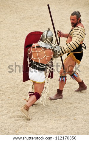 TARRAGONA, SPAIN - MAY 26: Gladiators on the arena of Roman Amphitheater on May 26, 2012 in Tarragona, Spain. Every year, the historic recreation program TarracoViva recreates a gladiators fight