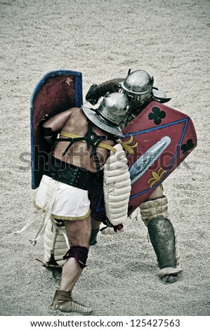TARRAGONA, SPAIN - MAY 26: Gladiators on the arena of Roman Amphitheater on May 26, 2012 in Tarragona, Spain. Every year, the historic recreation program TarracoViva recreates a gladiators fight
