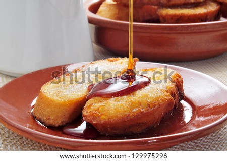 closeup of a plate with some torrijas, typical spanish dessert for Lent and Easter, with honey