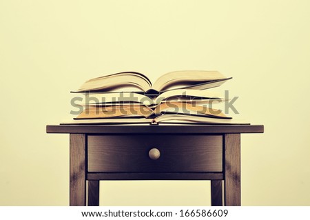 a pile of books on a desk symbolizing the concept of reading habit or studying