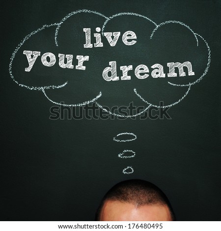 a man over a blackboard with a blank thought bubble drawn in it and the sentence live your dream