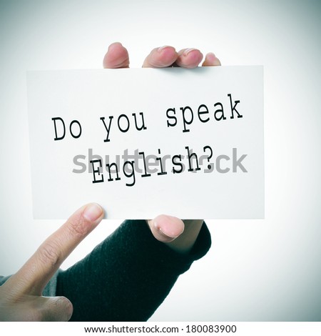 woman hands showing a signboard with the sentence do you speak english? written in it