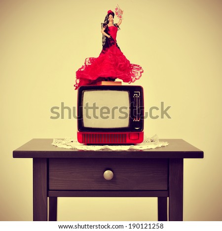 an old-fashioned spanish living room, with a flamenca doll in top of the television, with a retro effect