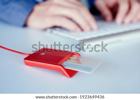 closeup of an electronic identification in a red reader on a front desk, and a young caucasian man, wearing an elegant blue suit sitting at the desk Photo stock © 