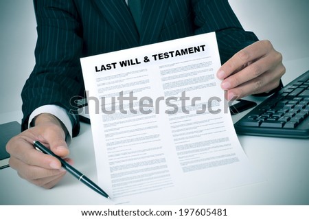 man in suit showing where the testator must sign in a last will and testament document Imagine de stoc © 
