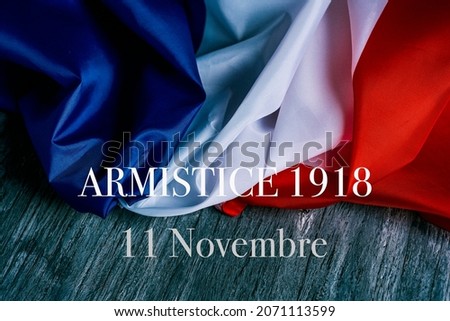the text armistice 1918 11 novembre, a public holiday held in france on 11 november, that commemorates the armistice at the end of the World War I, and a french flag on a gray rustic wooden background Foto d'archivio © 